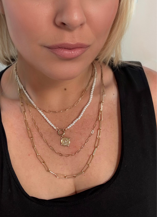 Model wearing evil eye layered necklace 