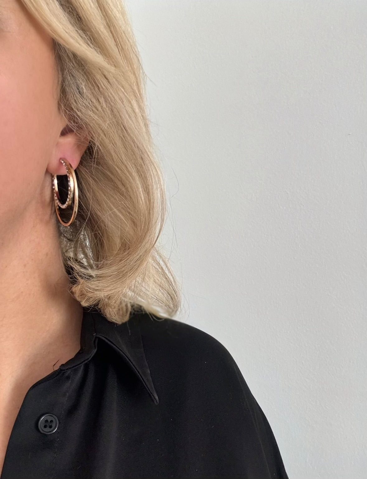 Model wearing gold hoop earrings 